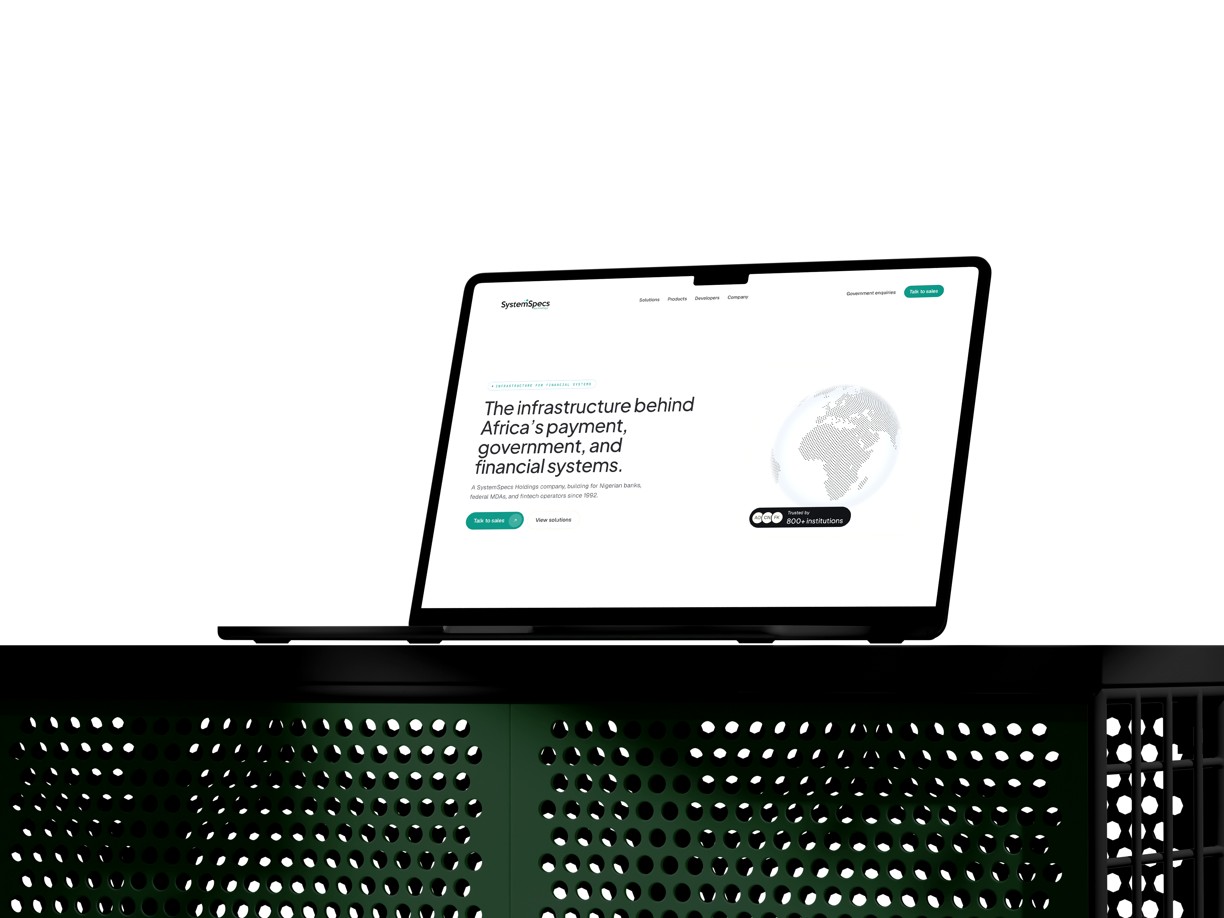 STSL homepage on a laptop, dark perforated surface, atmospheric green light